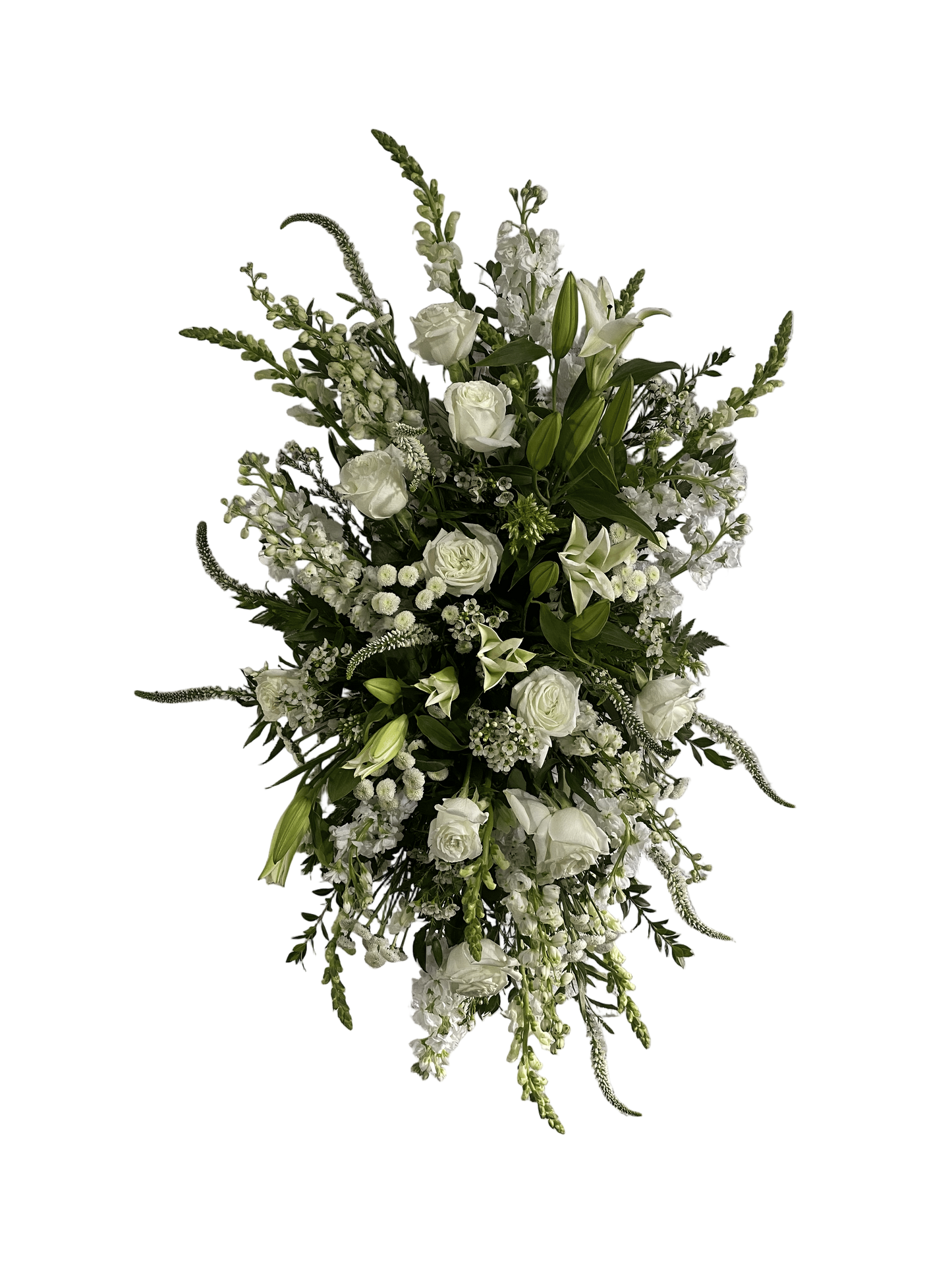a white standing floral spray featuring roses, snapdragons, stock, and more