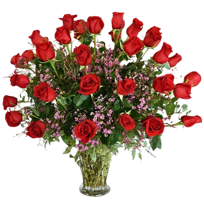 Bouquet of three dozen red roses with greenery and pink wax flower in a clear vase 