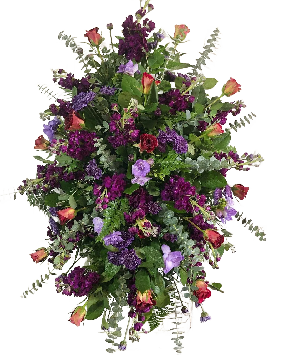 Colorful floral standing spray with purple stock, red roses, eucalyptus, and greenery with other flowers