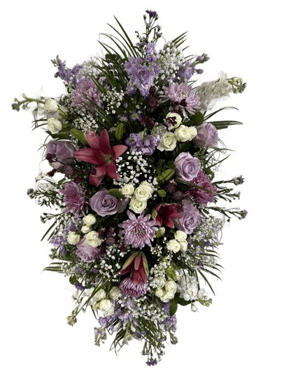 Standing spray flower arrangement with purple, pink, and white flowers 
