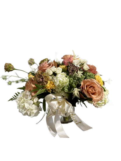 Bouquet of white, color, and yellow flowers with a white ribbon 
