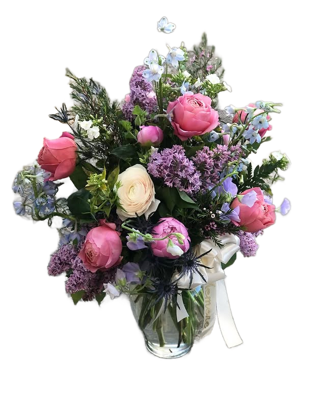 Bouquet of flowers with pink roses, white ranunculus, blue delphinium, and purple lilac in a clear vase