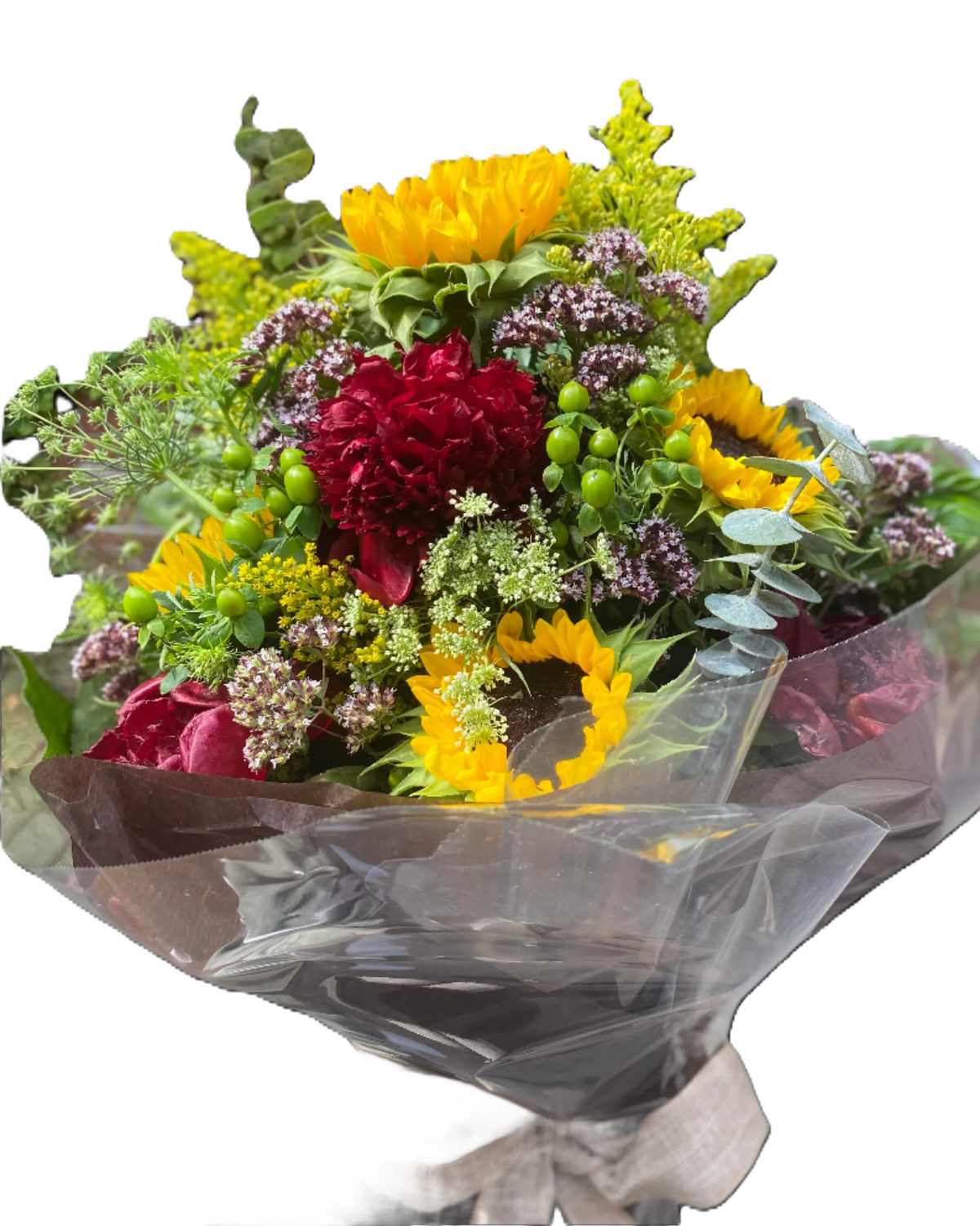 Bouquet of flowers with yellow sunflowers, red peonies, and green hypericum, wrapped in clear plastic and brown paper 