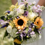 Bride holding Sunflower, lisianthus hydrangea bridal bouquet